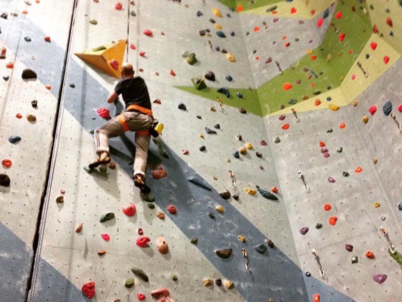 Photo of indoor wall climbing.